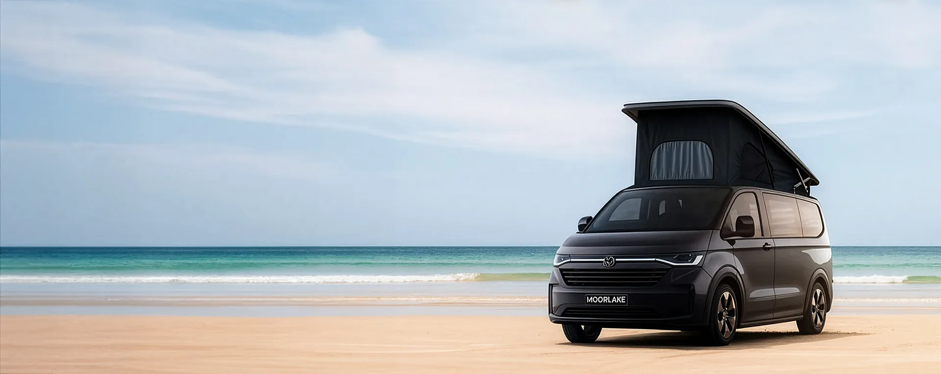 VW campervan T7 parked on the beach with pop-top roof - Moorlake